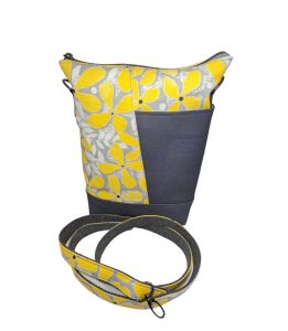 a handmade cotton canvas teloujay crossbody bag featuring a bold yellow and gray floral design