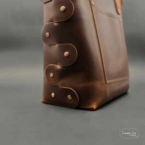 Brushed copper rivets on a leather bag