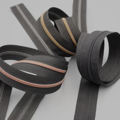 Black No.3 zip tape with different teeth colours.