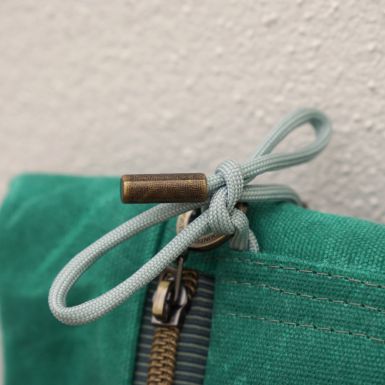 Brass end cap on light green cord